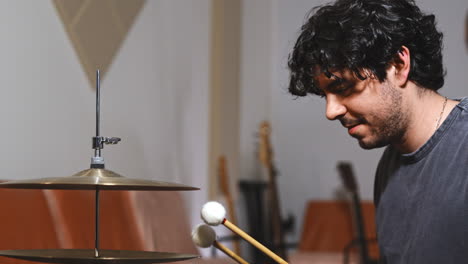 professional drummer musician play drum cymbal with drumstick in studio