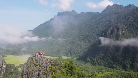 Aerial-View-Of-Nam-Xay-Viewpoint-In-Vang-Vieng,-Laos-With-Light-Clouds-Floating-Above