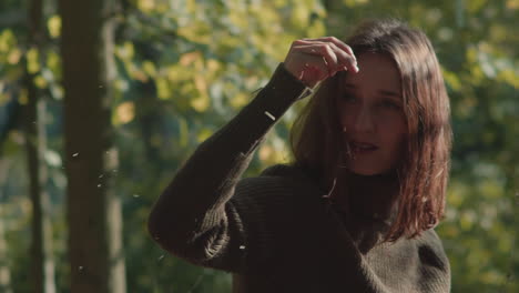 the woman watches in fascination as the wood crumbles in her palm