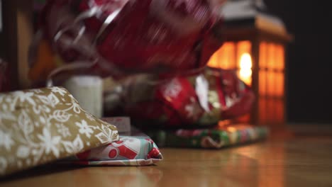 Weihnachtsgeschenke-Und-Die-Hand,-Die-Eines-Davon-Aufhebt,-Nahaufnahme,-Seitenansicht