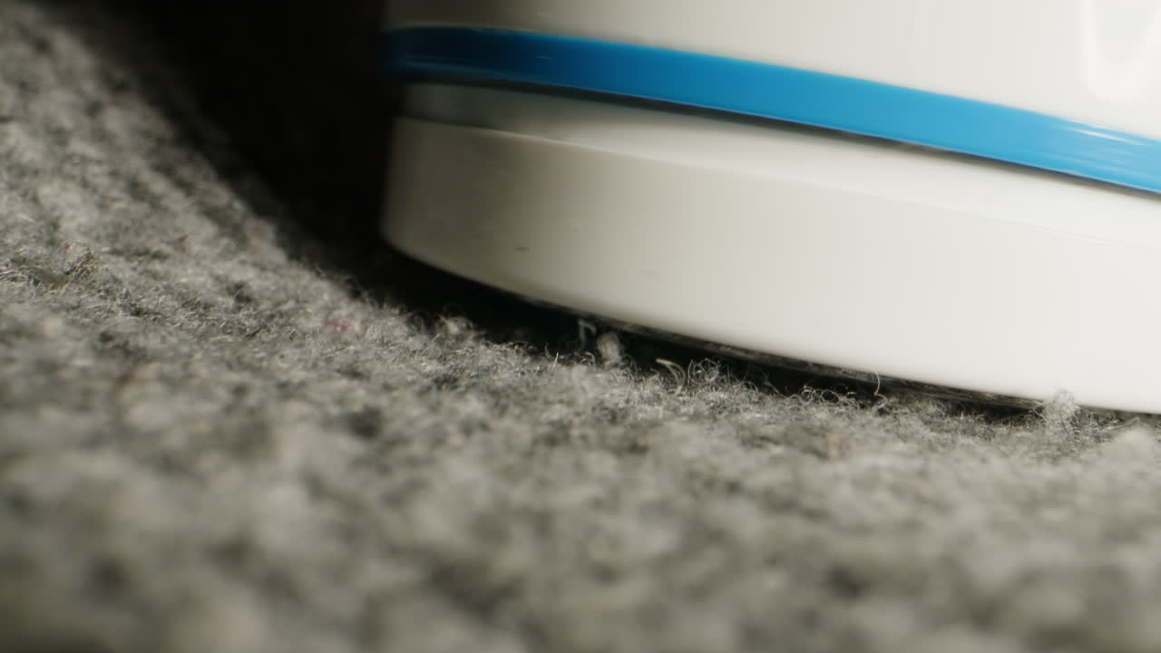 Machine for removing pellets close-up. Wool textile cloth texture close-up macro. Woolen background. Fashion fabric multicolor. Sheep wool for clothes . High quality 4k footage