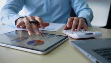 slow motion scene of accountant man using calculating on calculator to summarize or consider on statistic report at home office for business and financial concept