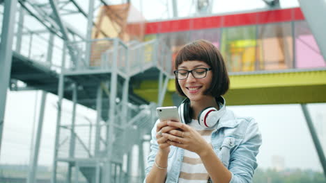 young woman texting on smartphone in urban setting