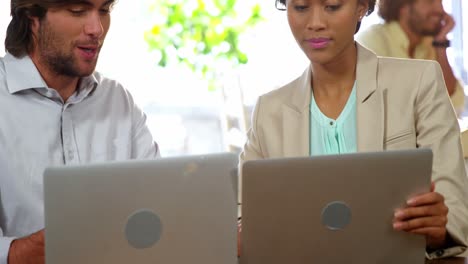 Businesspeople-using-laptop-during-meeting