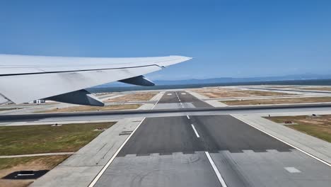 airplane take off from san francisco international airport, passenger pov over wing, california usa