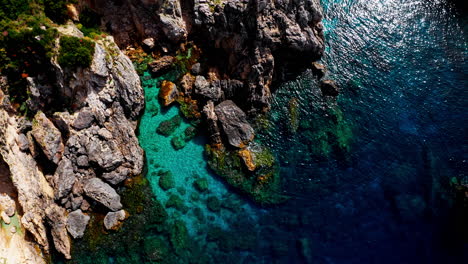 Top-down-aerial-drone-view-of-the-picturesque-rocky-coastline-of-Paleokastritsa-in-Corfu,-Greece