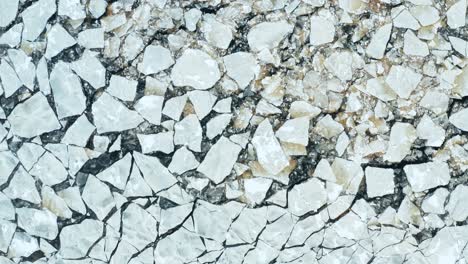 vuelo aéreo sobre la vista de los témpanos de hielo agrietados flotando en el mar