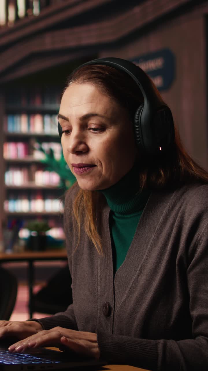 Vertical Video Woman listens to loud music on headset and disturbing other people