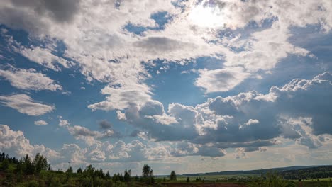 white clouds, clear soft sky, time lapse formating cloudscape in horizon, rainy rolling fast moving, beautiful summer sunny day, colourful weather.