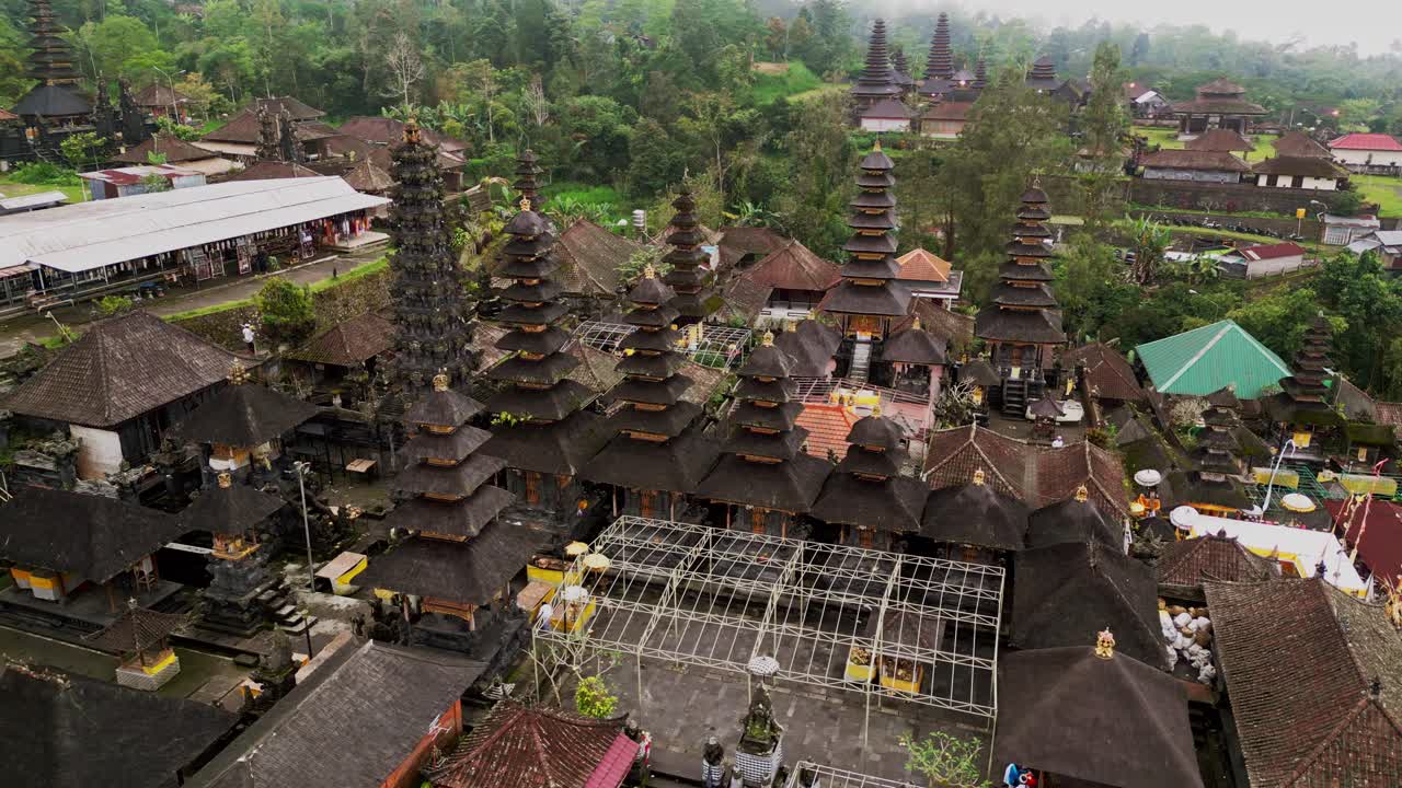 Aerial video showcases Besakih Great Temple, the holiest site in Bali, with its multi-tiered pagodas rising from a vast hillside, blending sacred architecture with the island’s natural beauty.