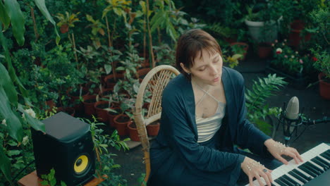 talented woman playing keyboard and singing in indoor garden