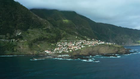 traditional village seixal on wild coast of madeira island with majestic cliffs