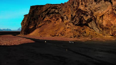 iceland's black beach car follow aerial shot