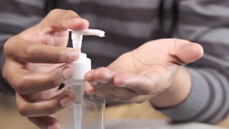 applying hand sanitizer