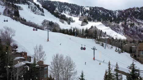 Ski-tracks-in-Aspen-with-cable-cars-in-fast-ascending-reveal-drone-shot