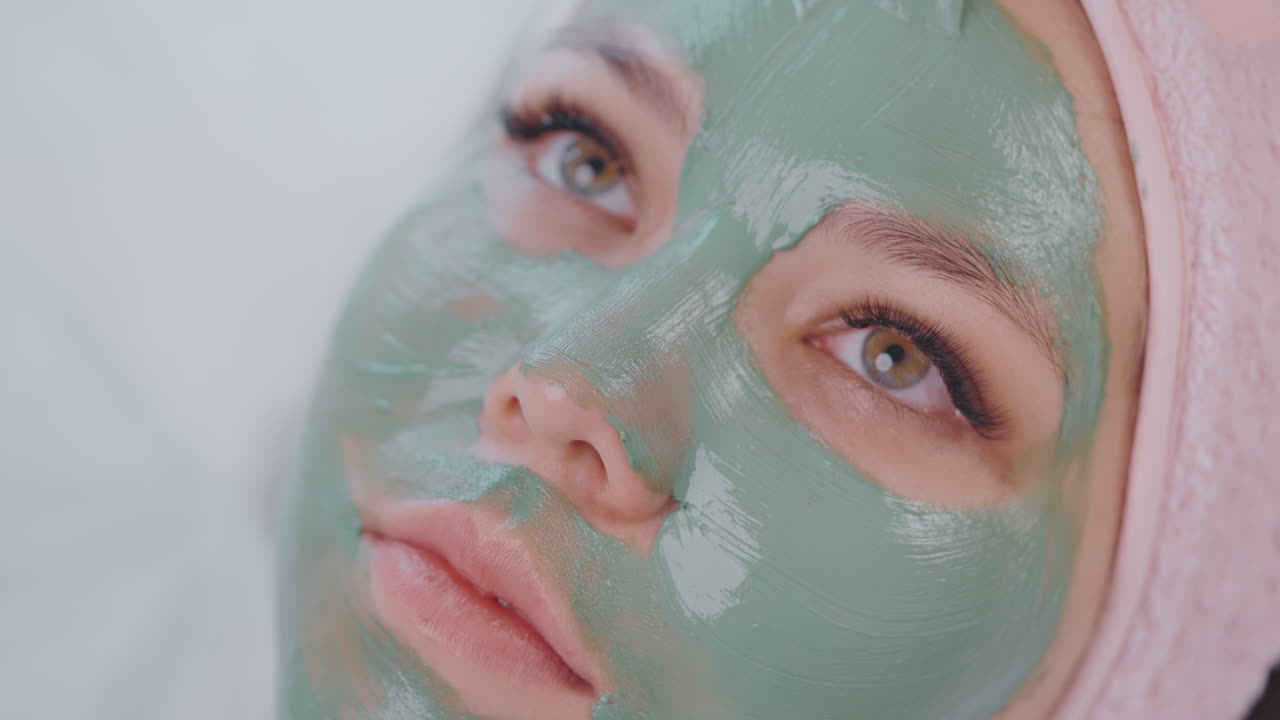 Woman Receiving a Green Clay Facial Mask