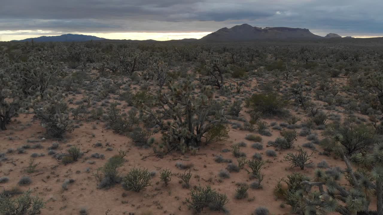 lento vuelo aéreo hacia atrás sobre un espectacular paisaje desértico y una tormenta inminente