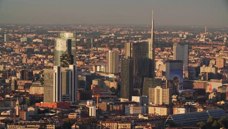 porta nuova of milan city during golden sunset, view from above