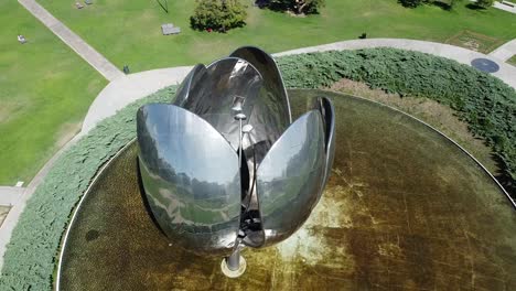 ascending aerial view over large metal tulip sculpture which is famous site in buenos aires, argentina