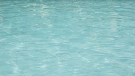 Swimming-Pool-water-surface-Reflecting-On-A-Sunny