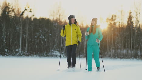 loving man and woman skiing in the winter forest doing outdoor activities leading a healthy lifestyle. slow motion