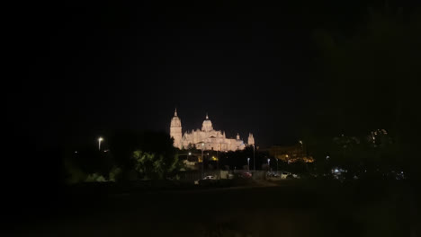 Beautiful-shot-of-the-impressive-famous-cathedral-of-Salamanca-Spain,-across-the-Tormes-River-during-a-clear-night