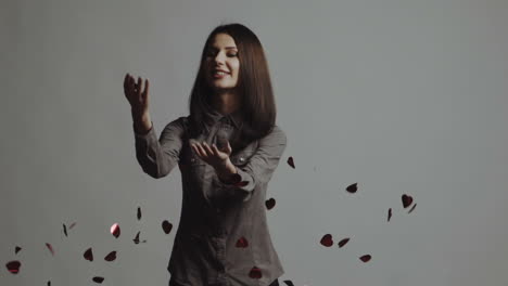 red hearts confetti, falling background of a beautiful girl. slow motion