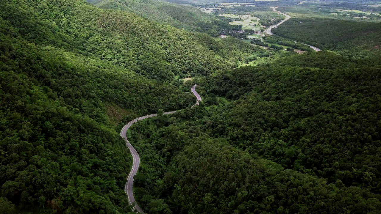 concepto logístico vista aérea de la carretera rural - autopista que atraviesa la serena y exuberante vegetación y el follaje del bosque tropical lluvioso paisaje montañoso
