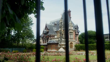 historic european villa through a fence