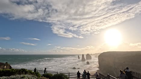 sunset over ocean cliffs with people observing