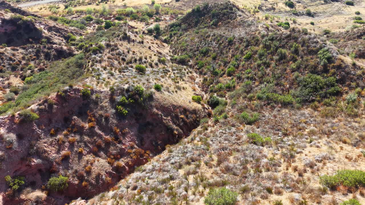 Aerial shot of rugged terrain and dry vegetation in Black Star Canyon Wilderness, California