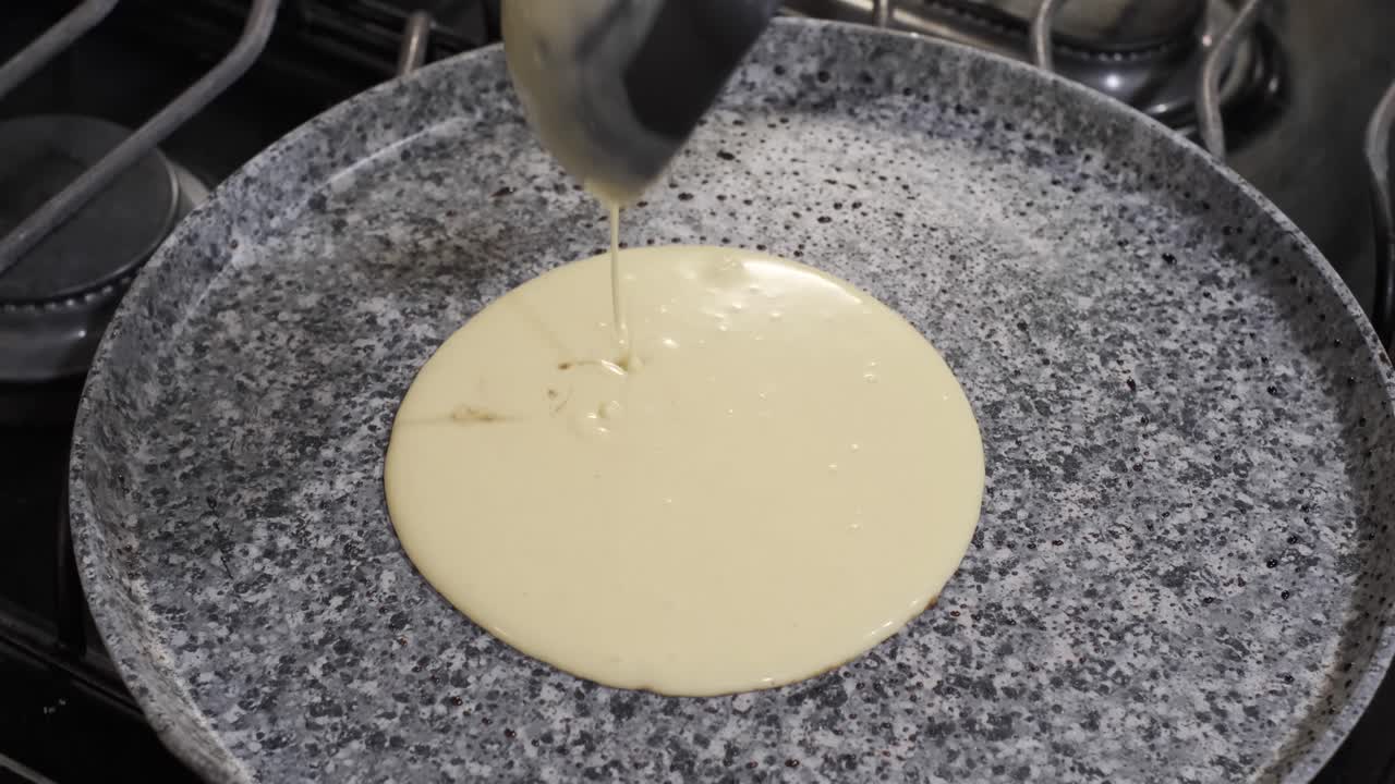 cuchara de cucharón vierte la masa de panqueques en una sartén caliente, desayuno de panqueques, cierre