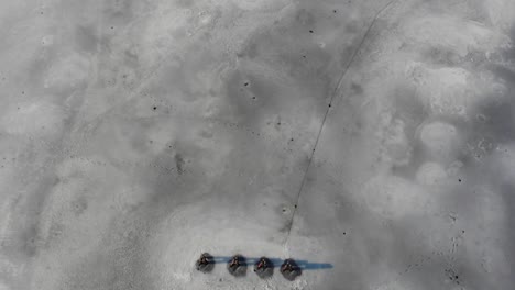 top down view on frozen pier with camera tilt to ice lake in background