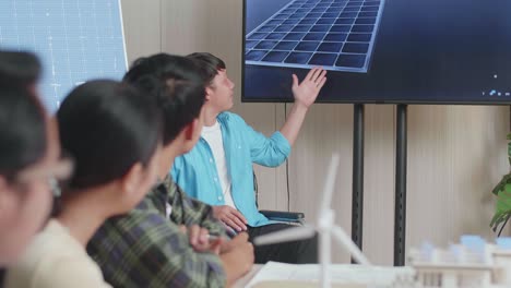 asian man engineer in wheelchair presenting about the work of solar cell to his colleagues at the office
