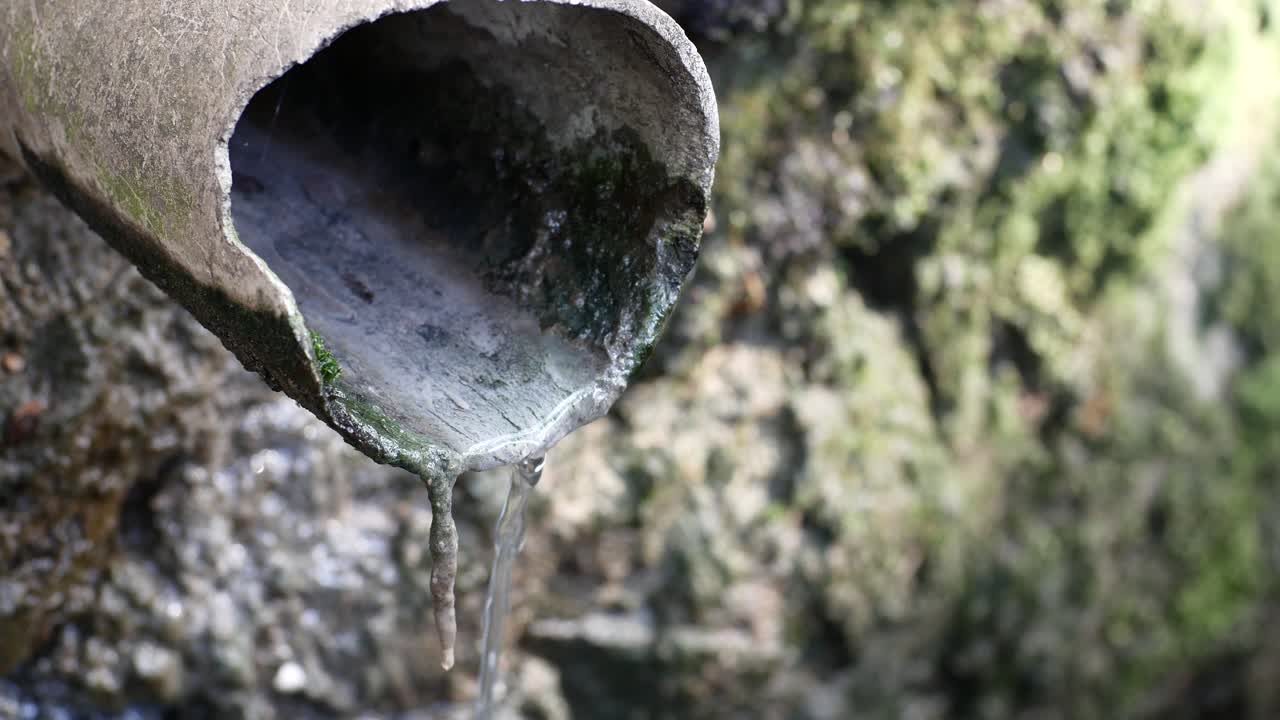 wastewater flows down an old pipe