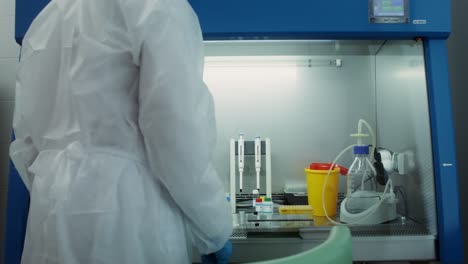 scientist working in a fume hood in a laboratory setting