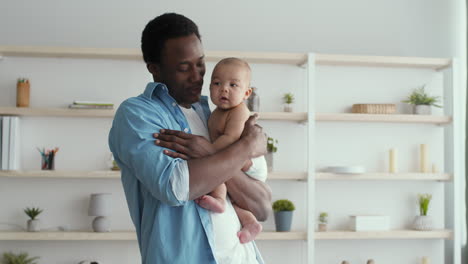 african american father embracing his baby
