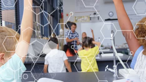 Animation of chemical icons over diverse schoolchildren raising hands in classroom