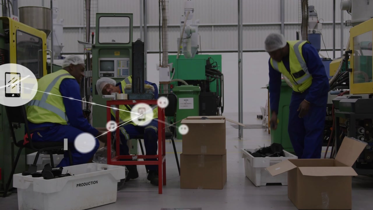 3 workers assembling parts center male gesturing starting overlay nodes obscuring them to monitor