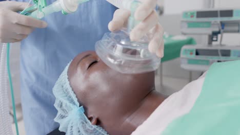 sleeping african american female patient with oxygen mask during surgery in slow motion, unaltered