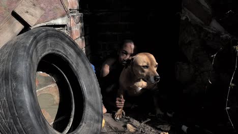 homeless child hugs his dog for comfort