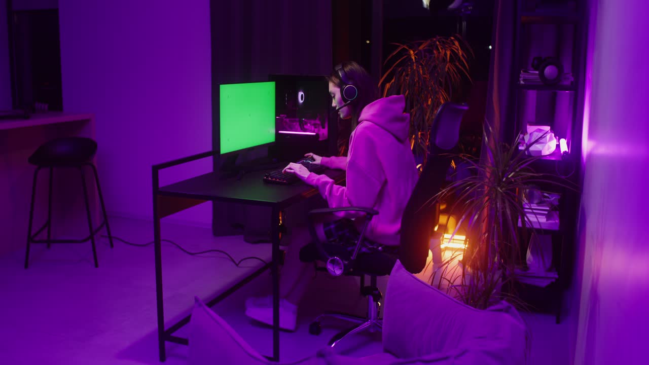 Woman playing video games at her computer