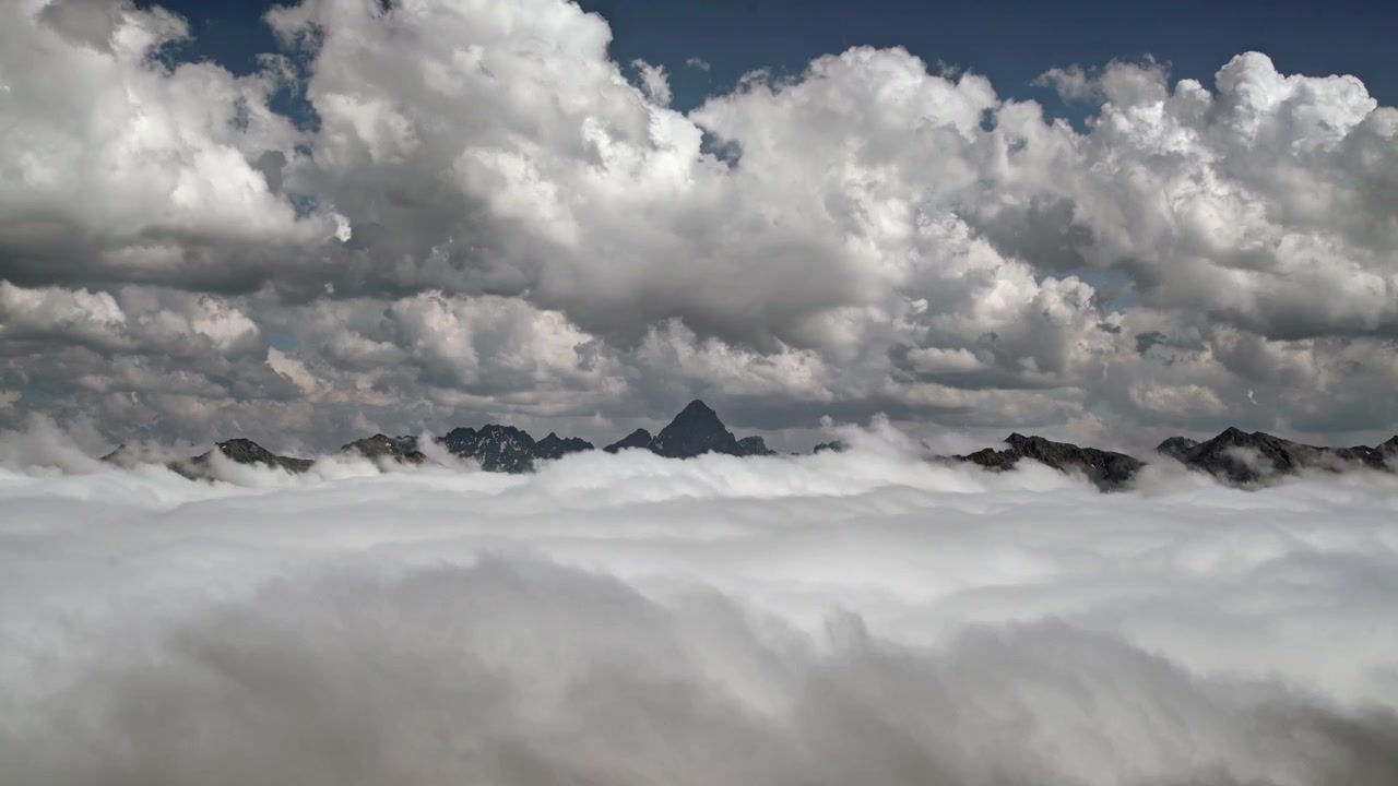 Aerial View of Mountain Peaks Rising Above a Sea of Clouds