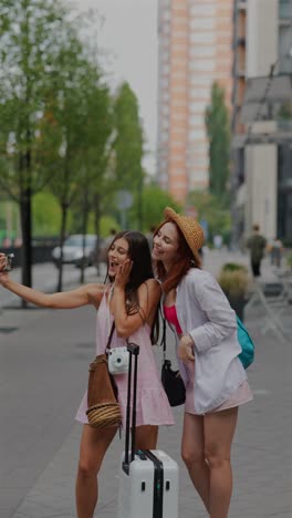 two friends taking a selfie on a city street