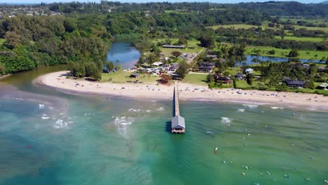 aerial view of a beautiful beach with pier and people