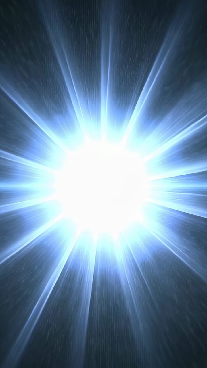 Video verticale: nucleo in espansione che alimenta la crescita di punti luce nel buio, inviando raggi a stella e granelli