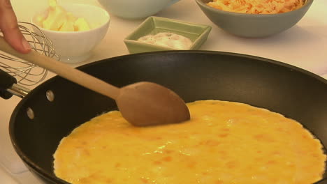 an omelet is cooked in a pan