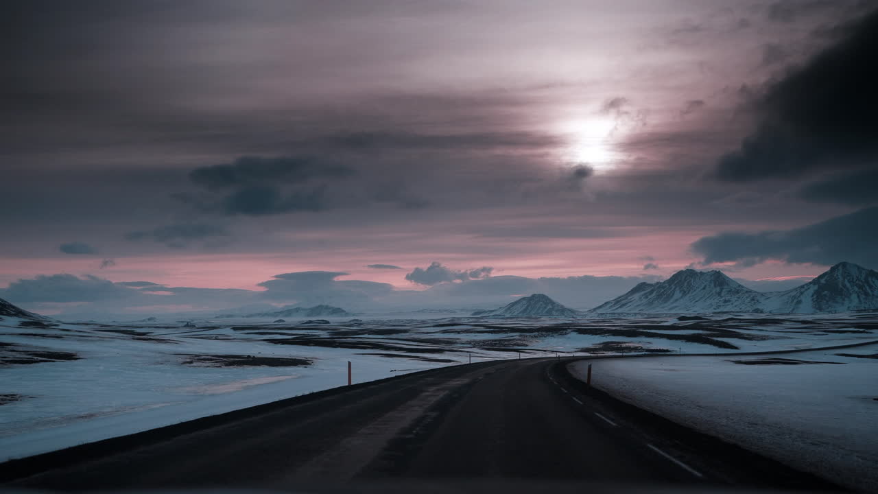 Video di guida POV attraverso il paesaggio innevato dell'Islanda settentrionale al tramonto, che cattura la serena bellezza invernale e la luce soffusa
