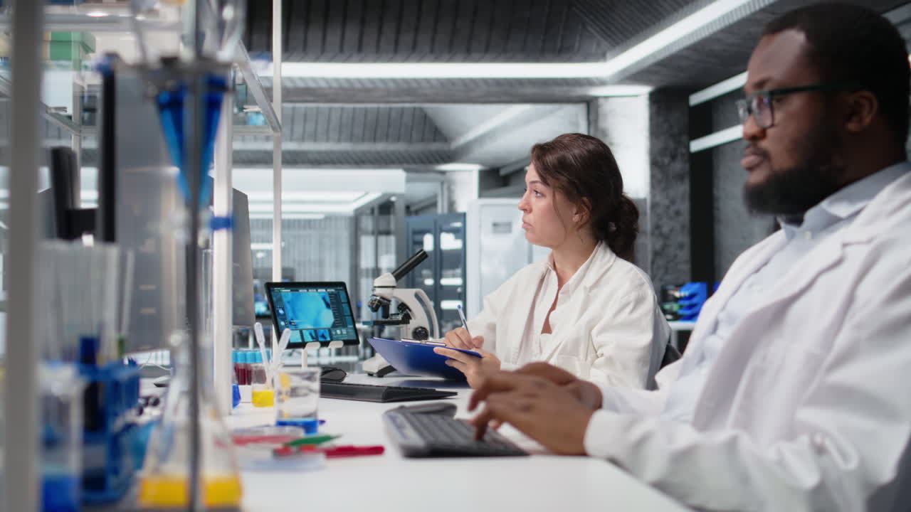 Vertical video Clinical laboratory technologist writing observations from laboratory experiment