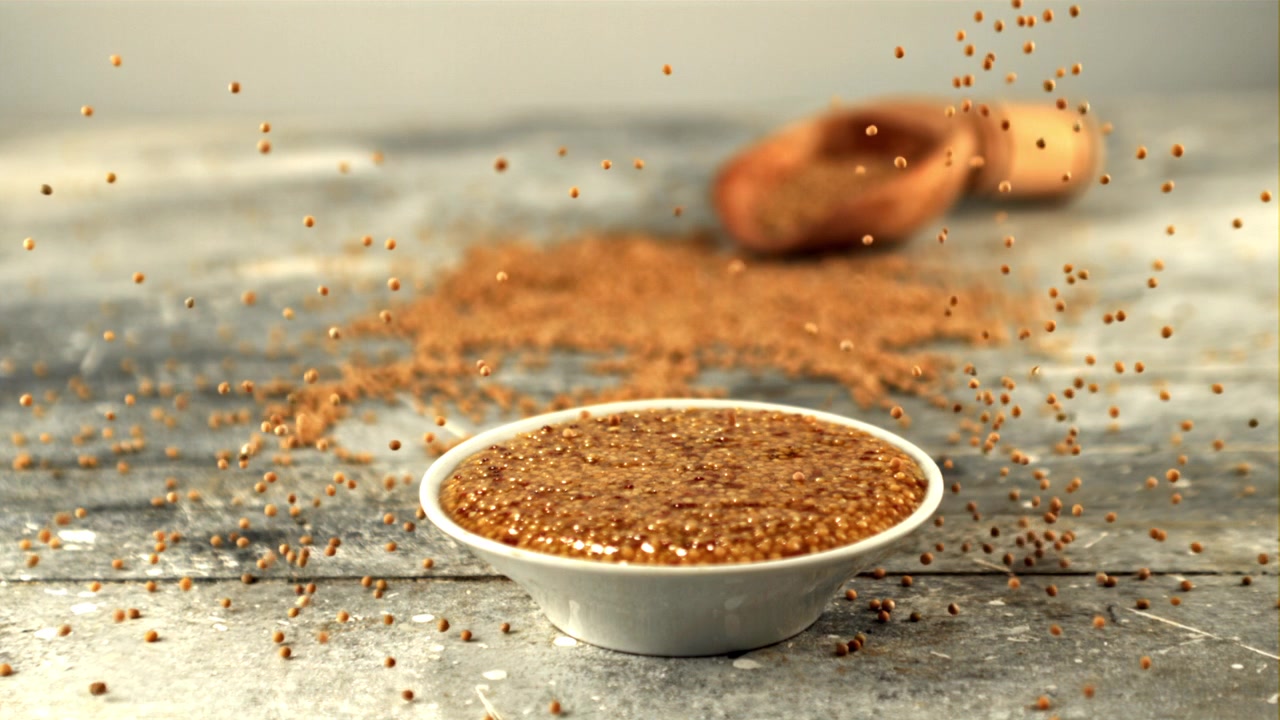 Mustard Seeds Falling into a Bowl of Whole Grain Mustard